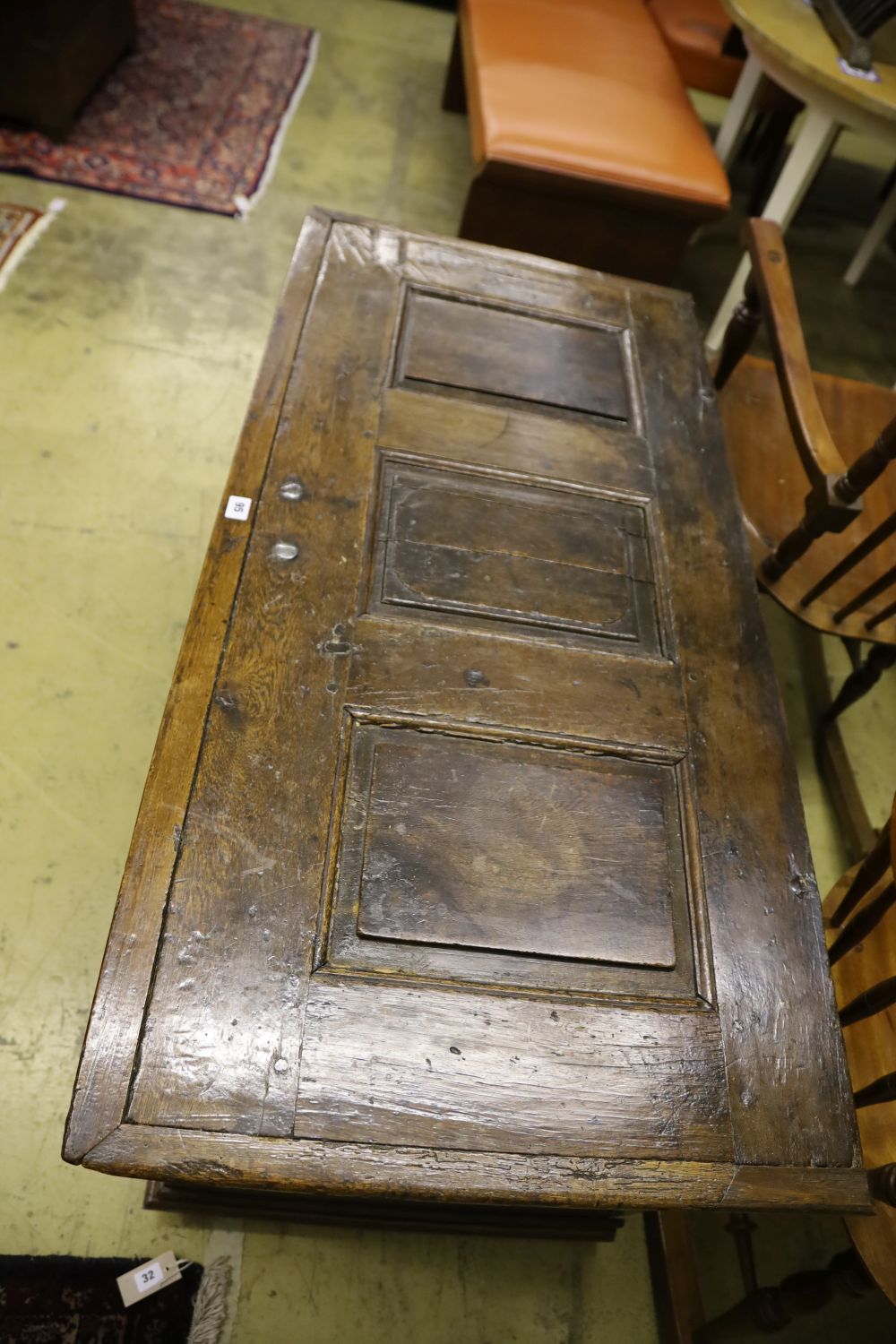 An 18th century panelled oak coffer, width 128cm, depth 61cm, height 64cm